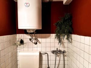 a bathroom with a sink and a water fountain at Loft Sava View Old Town Renovated in Belgrade