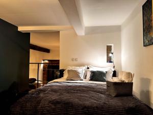 a bedroom with a large bed with white pillows at Loft Sava View Old Town Renovated in Belgrade