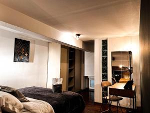 a bedroom with a bed and a table and a desk at Loft Sava View Old Town Renovated in Belgrade