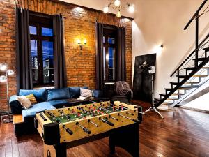 a living room with a foosball table at Loft Sava View Old Town Renovated in Belgrade