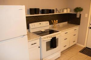 a kitchen with a white stove and a refrigerator at Hidden Treasure in Longview