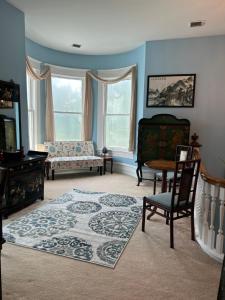 a living room with a couch and a chair at Enloe House in Roanoke