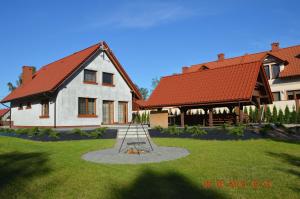 a house with a playground in the yard at Dom na Mazurach in Rydzewo