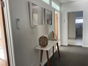 a room with a table with a lamp on it at The Wheelhouse - 2BR Waterfront Apt in town in Lakes Entrance
