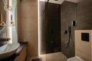 a bathroom with a shower with a sink and a toilet at SKY Home- Wood Penthouse -Manufaktura, Parking, Klimatyzacja, Dostęp na Kod in Łódź +13 photos