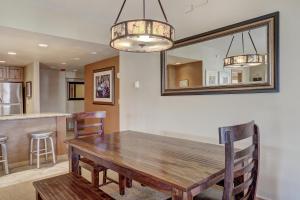 a dining room with a wooden table and a mirror at Ski In-Out Village at Breckenridge Condo in Breckenridge