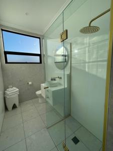 a bathroom with a glass shower and a toilet at 4BR Waterfront - Skippers Quarterdeck in Lakes Entrance