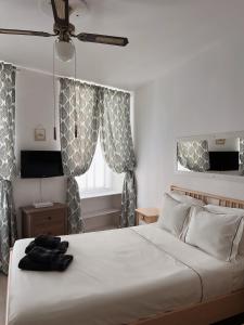 a bedroom with a white bed and a window at Engineer Lane House in Gibraltar
