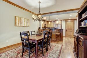 uma cozinha e sala de jantar com uma mesa de madeira e cadeiras em Luxurious 2 Bedroom Condo 50 Feet From The Slopes! condo em Beaver Creek