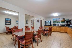 a restaurant with tables and chairs and a kitchen at SureStay Plus Hotel by Best Western Buffalo in Buffalo