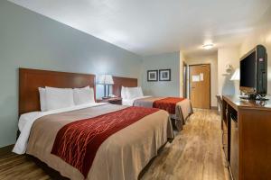 a hotel room with two beds and a flat screen tv at SureStay Plus Hotel by Best Western Buffalo in Buffalo