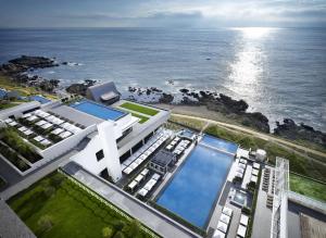 an aerial view of a building by the ocean at Ananti at Busan Cove in Busan