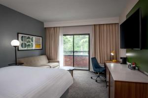 a hotel room with a bed and a desk at Sonesta Select Boston Foxborough Mansfield in Foxborough +24 photos