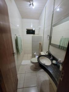 a bathroom with a sink and a toilet at Casa para sua família in Bonito +11 photos