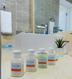 four plastic bottles sitting on a counter in a bathroom at Hermoso apartamento 1 hab a pasos de la playa in Punta Cana