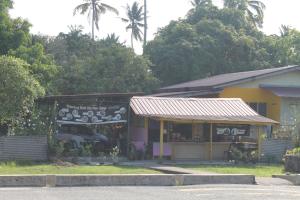 a small store with a sign in front of it at Kuantan Homestay WiFi Viu PS4 BBQ by Zaryqa in Kuantan