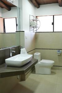 a bathroom with a sink and a toilet at Hotel Pilancones in Cajamarca