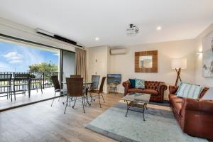 a living room with a couch and a table at Illawong Apartments in Mooloolaba