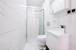 uma casa de banho branca com um WC e um chuveiro em Renovated Modern Flat in Istiklal Avenue em Istambul
