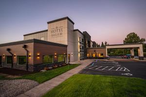 a hotel with a parking lot in front of a building at The Hotel Salem in Salem