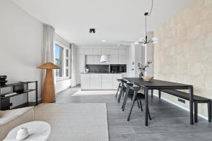 a kitchen and dining room with a black table and chairs at City View Lux in the City Center with Free Parking in Reykjavík