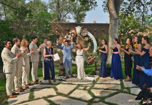 a bride and groom standing in front of a group of people at Inn on La Loma Plaza in Taos