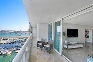 a balcony with a view of a marina at Only in My Dreams! Direct Water View Luxury Condo in Miami