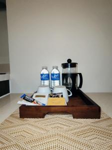 a table with a coffee maker and a coffee pot and a coffeemaker at Family Room in Maribago