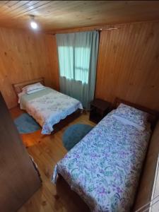 Un ou plusieurs lits dans un hébergement de l'établissement Hostal Turismo Allipen