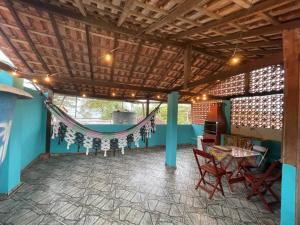 a patio with a hammock and a table and chairs at Nova Conquista in Paraty