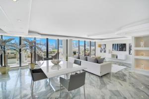 a living room with a white table and chairs at Sea Forever! Miami Skyline And Water Views in Miami
