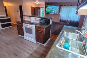 a kitchen with a sink and a stove top oven at Chill Retreat in great location (parking onsite) in Wilmington