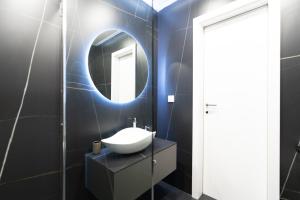 a bathroom with a sink and a mirror at Arena MALL Galleria View and Securities Parking1 in Burgas City