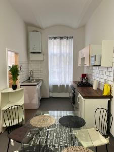 A kitchen or kitchenette at Magic Moment Apartment
