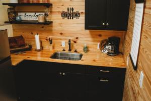 a kitchen with a sink and a wooden counter top at WATERFRONT LUXURY GLAMPING DOME in Rogersville