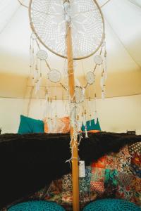 a fan hanging from the ceiling of a bedroom at The Pisces-a stargazing, luxury glamping tent in Rogersville +25 photos