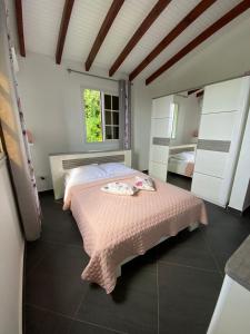 a bedroom with a pink bed and a window at Villa NKJ'S in Deshaies