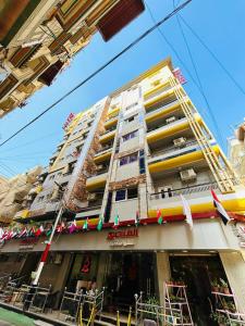 a tall building with balconies on the side of it at El Mansour Hotel apartmen 74 in Mansoura