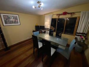 a dining room with a glass table and chairs at MY WAY Apartment in Cusco