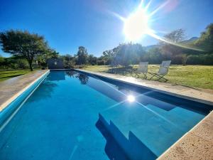 a swimming pool with the sun in the background at Posada Villapancha B&B in San Javier