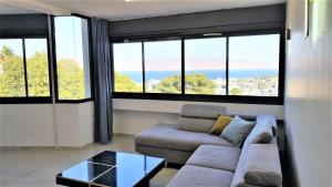 a living room with a couch and some windows at 4bdrm - 110mr - Dream vacation apartment in Tiberias