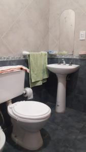 a bathroom with a toilet and a sink at La Nona in El Carmen