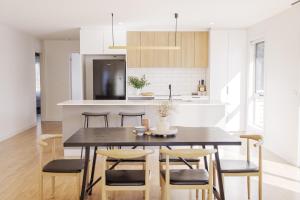 霍巴特Cozy Home Close to Beach and Hobart CBD的配有桌椅的厨房和餐厅
