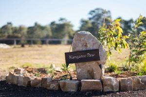 a sign on a rock in a garden at Kangaroo Paw @ The Beltree in Belford