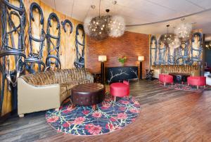 a lobby with a couch and chairs and a wall with graffiti at Hotel Indigo Cleveland Beachwood by IHG in Beachwood