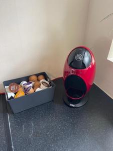 a toaster sitting next to a box of donuts at Honeycomb Cottage in Newburgh