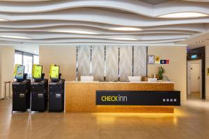 a checkin counter in an airport with aitating at CHECK inn New Taipei LuZhou in Taipei