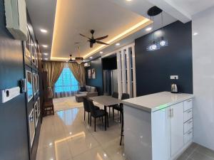 a kitchen and dining room with a ceiling fan at Homestay Naufal Bandar Sri Sendayan Ground Floor in Seremban