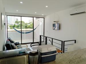 ein Wohnzimmer mit einem Tisch und einem großen Fenster in der Unterkunft CASA RODADERO SANTA MARTA in Santa Marta