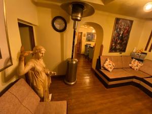 a statue of a man standing in a living room at My Way GUEST HOUSE in Cusco